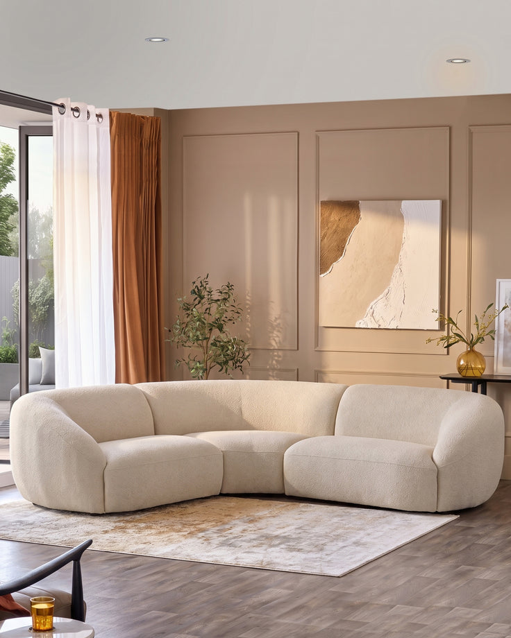 Kimberley square corner sofa in natural fabric, curved design in beige living room setting.