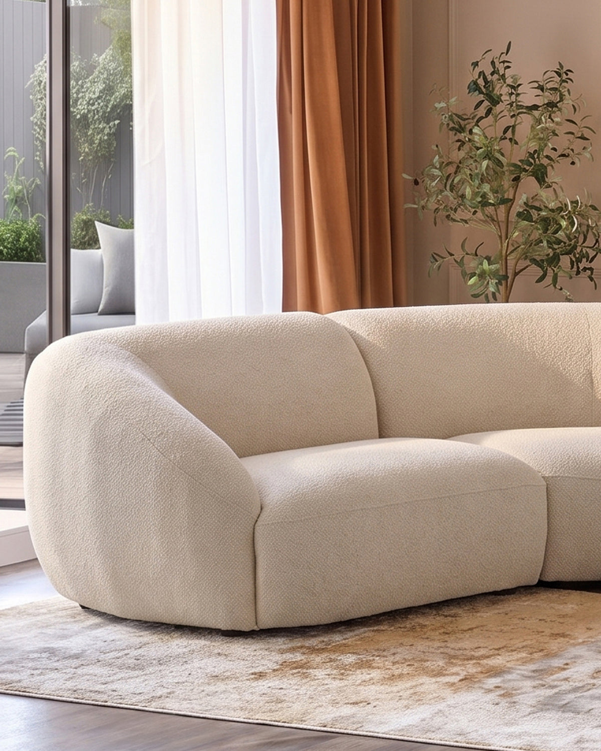 Kimberley square corner sofa in natural fabric with curved, rounded arms and cushioned seating in a modern living room.