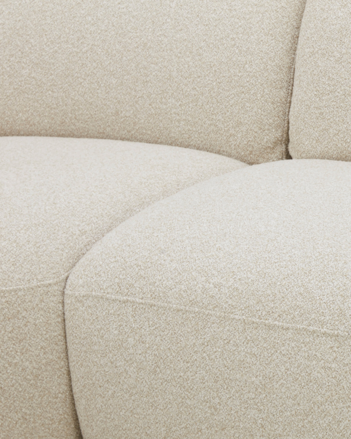 Kimberley 3-seater sofa in natural fabric, close-up detail of curved seating and backrest.