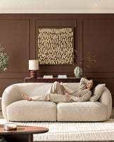 Kimberley 3-seater sofa in natural fabric with curved arms, displayed in a styled living room setting.
