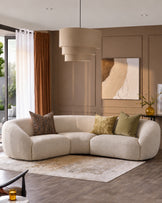 Kimberley square corner sofa in natural fabric, curved design with rounded arms, displayed in beige living room setting.