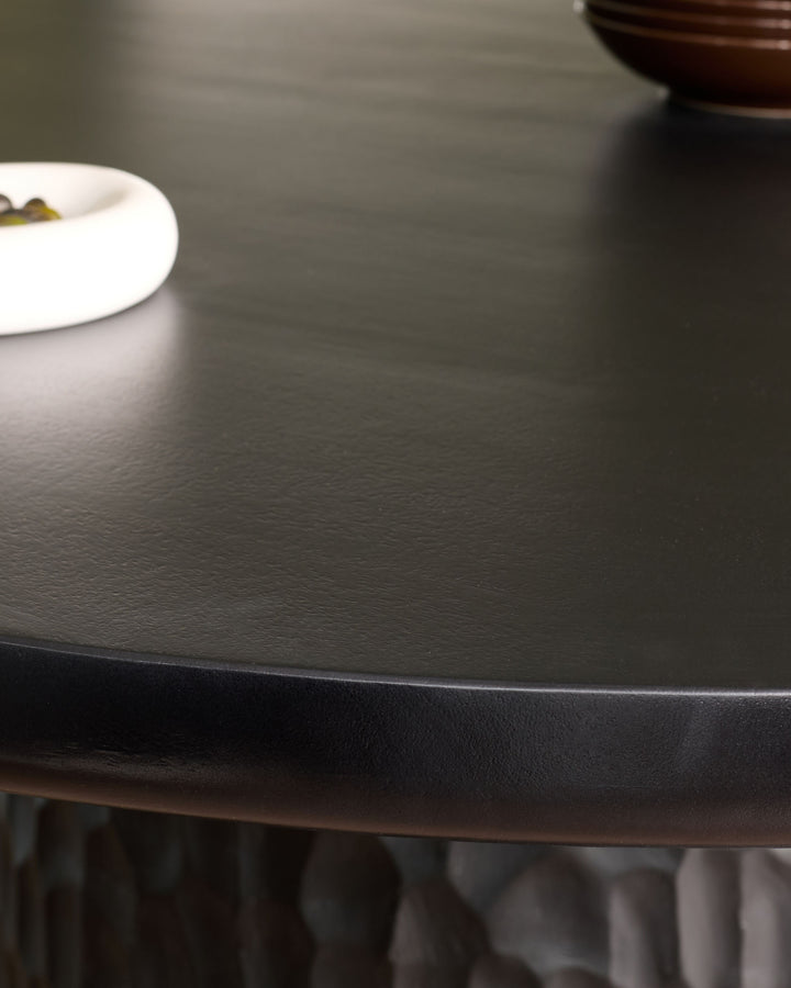 Knox 6-seater dining table in black wood, top-down view showing smooth matte finish and round tabletop edge detail.