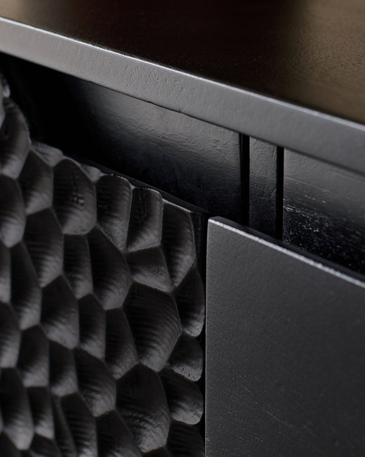 Close-up of black wooden sideboard handle and textured surface detail