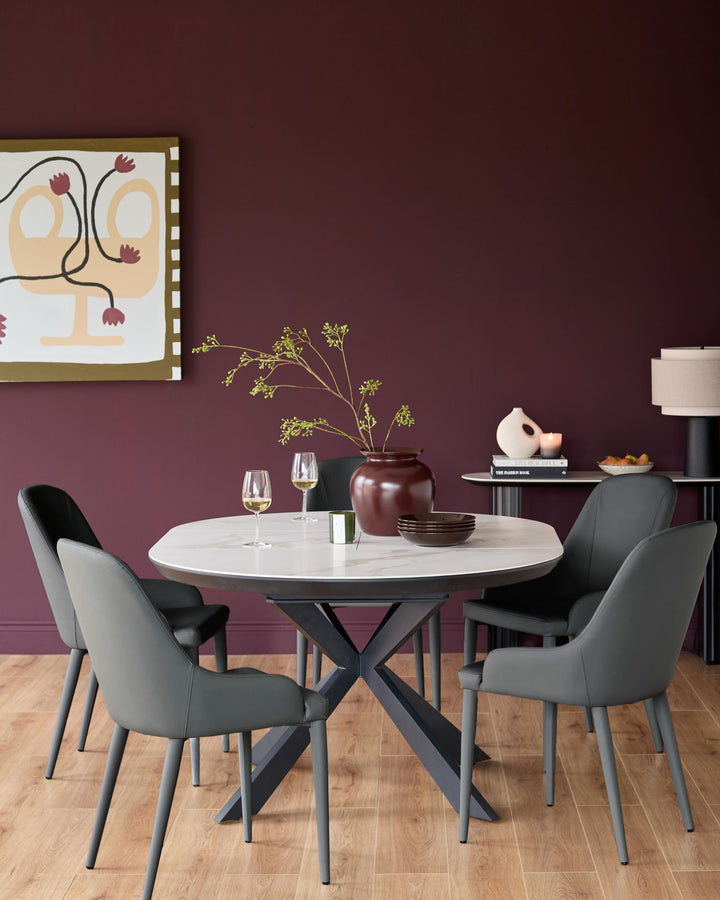Dark grey faux leather dining chair with curved backrest and tapered legs, shown in modern dining room setting.