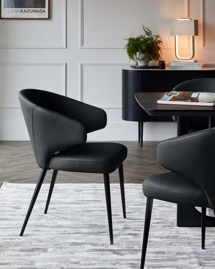 Landon black leather dining chair with curved backrest and metal legs, shown in modern room setting.