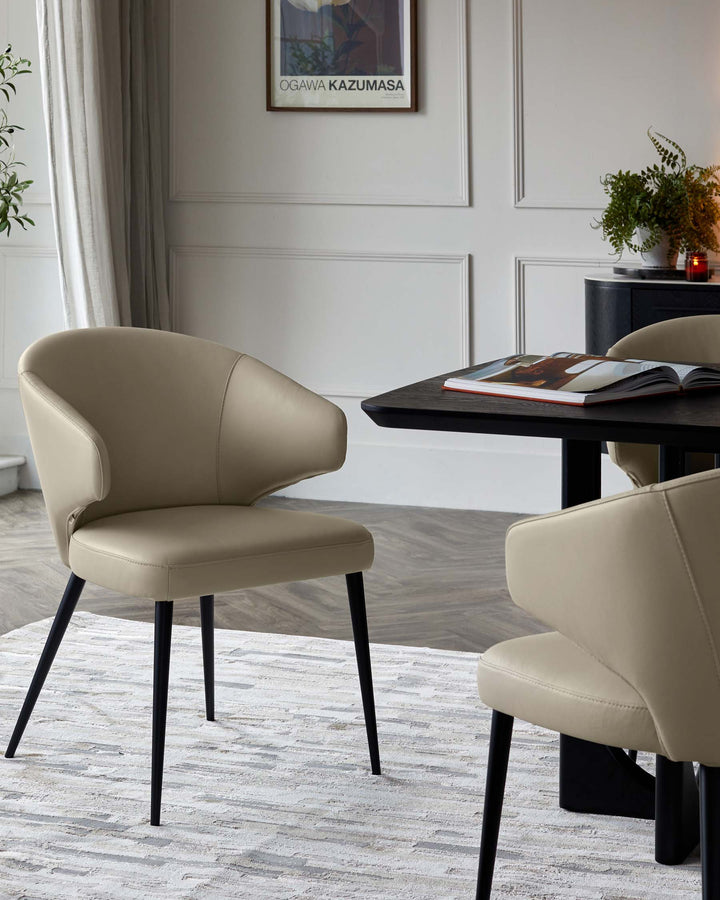Elegant beige chairs with black legs beside a sleek black table, complemented by a soft area rug and contemporary decor.