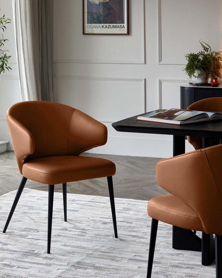 Tan leather dining chair with curved backrest and black metal legs, shown in a modern dining room setting.