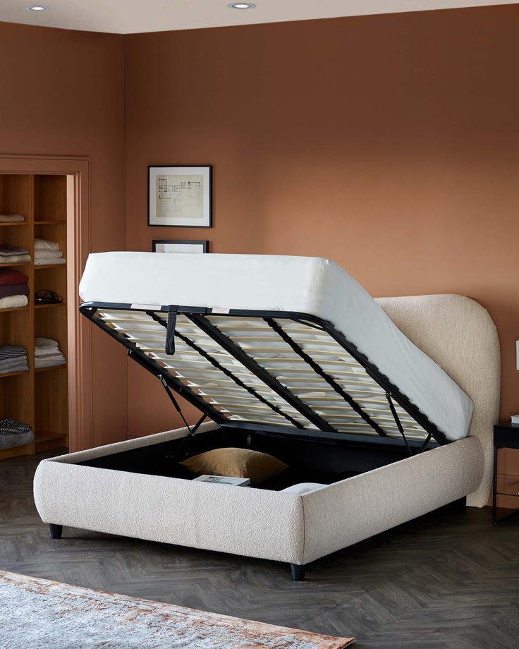 Stylish upholstered bed with a lift-up design, revealing hidden storage space underneath, set against a warm-toned wall.