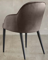 Lani dining chair in mocha velvet, rear view showing curved backrest and tapered black legs on light wood flooring.