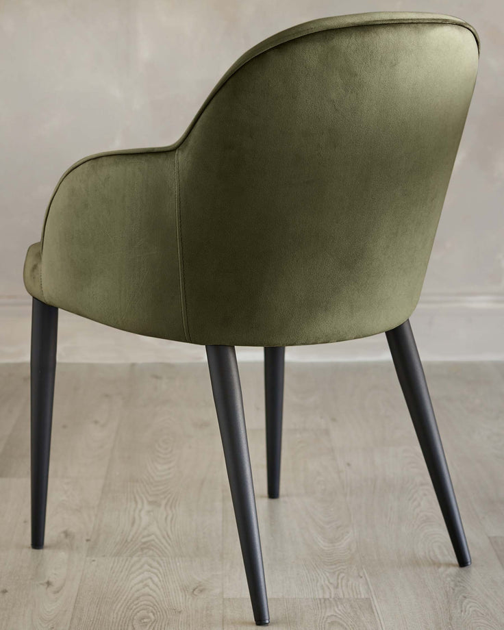 Stylish olive green upholstered chair with sleek black legs, offering a modern and elegant touch to any space.