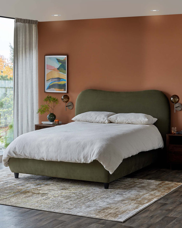 A stylish bedroom set, showcasing an olive green bed, wooden side tables and a textured rug on a dark wood floor.