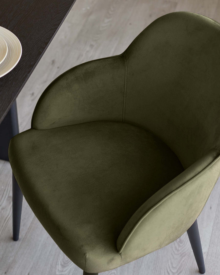 Lani dining chair in olive green velvet, overhead view showing curved backrest and seat cushion with dark legs.