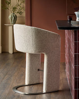 Leighton bar stool in grey fabric with black steel cantilever base, shown in modern interior setting.