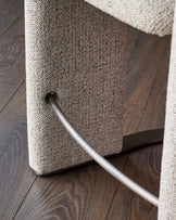 Grey fabric cantilever bar stool with chrome footrest and black steel frame detail.