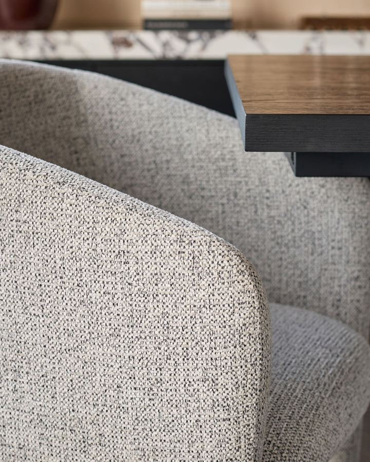 Leighton dining chair in grey chenille fabric with black metal frame, close-up detail view.