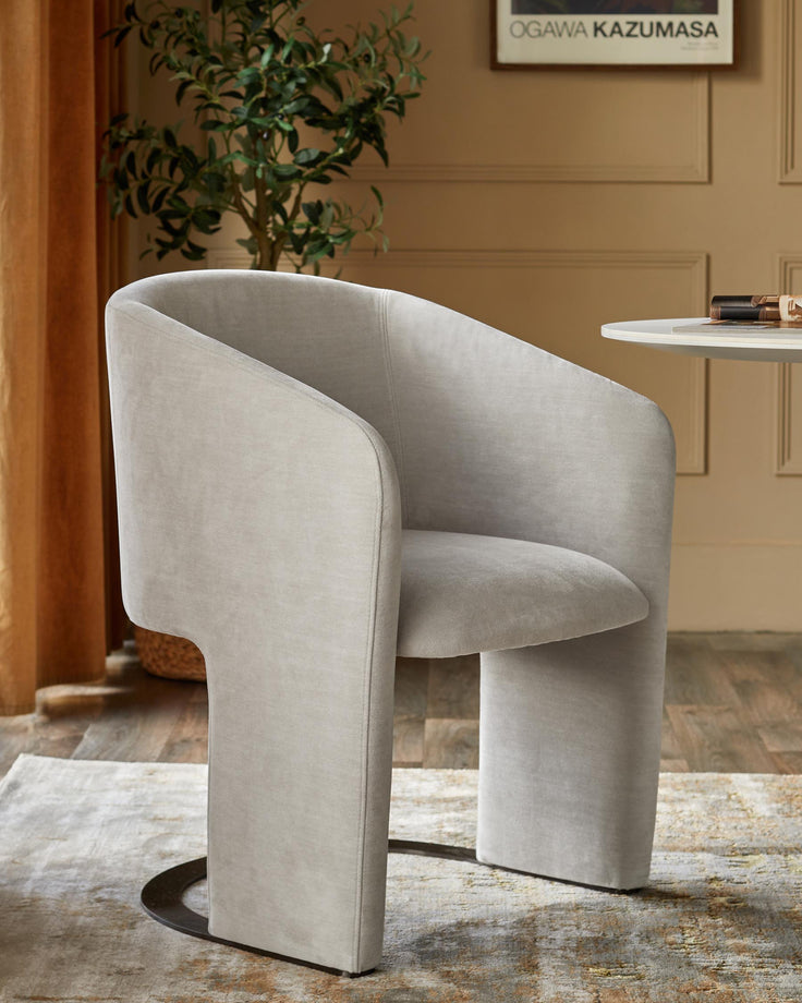 Stylish grey upholstered chair with curved back. Elegant seating for the contemporary home.