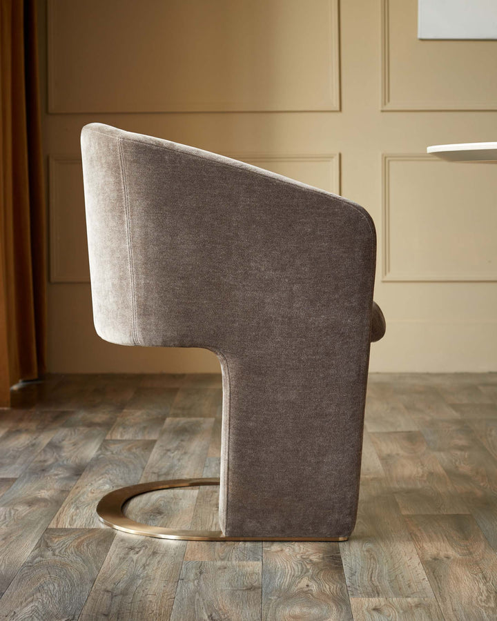 Modern armchair in brown upholstery with curved golden metal base. Contemporary furniture design.