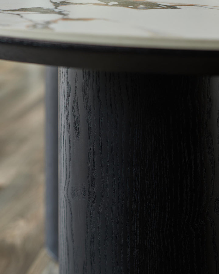 Close-up of a stylish, dark-stained wooden table leg and marble table top. Modern furniture design.