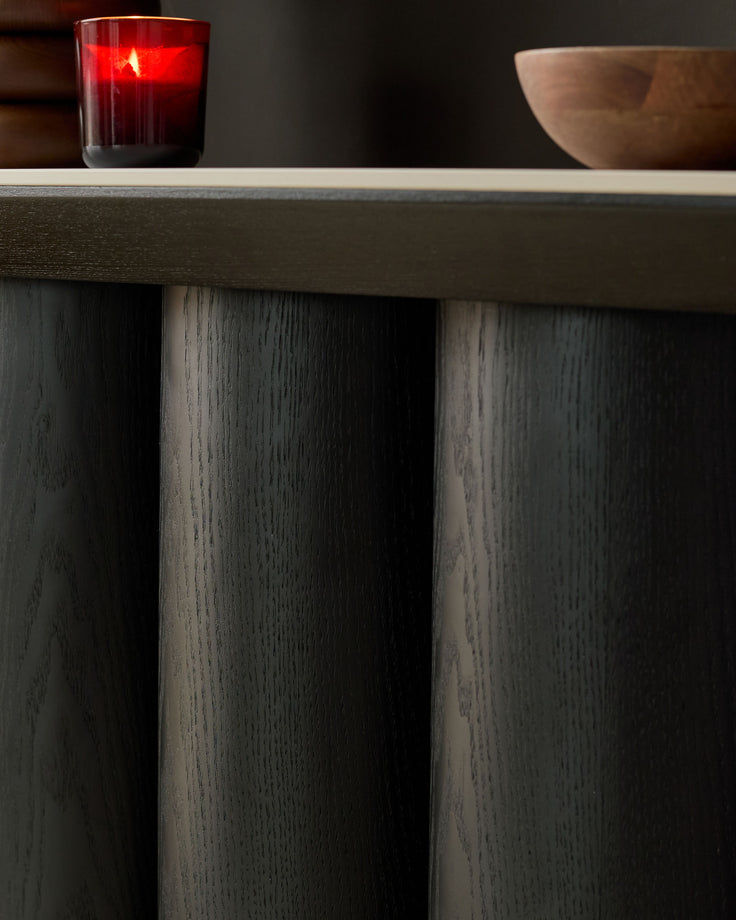 Lena console table with dark wood grain finish, showing closed cabinet doors and light wood top edge detail.