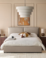 Bedroom featuring a neutral upholstered bed with a modern pendant light and dark wood bedside tables.