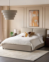 Bedroom with neutral colours, featuring a bed, bedside tables, rug, painting and light fixture.