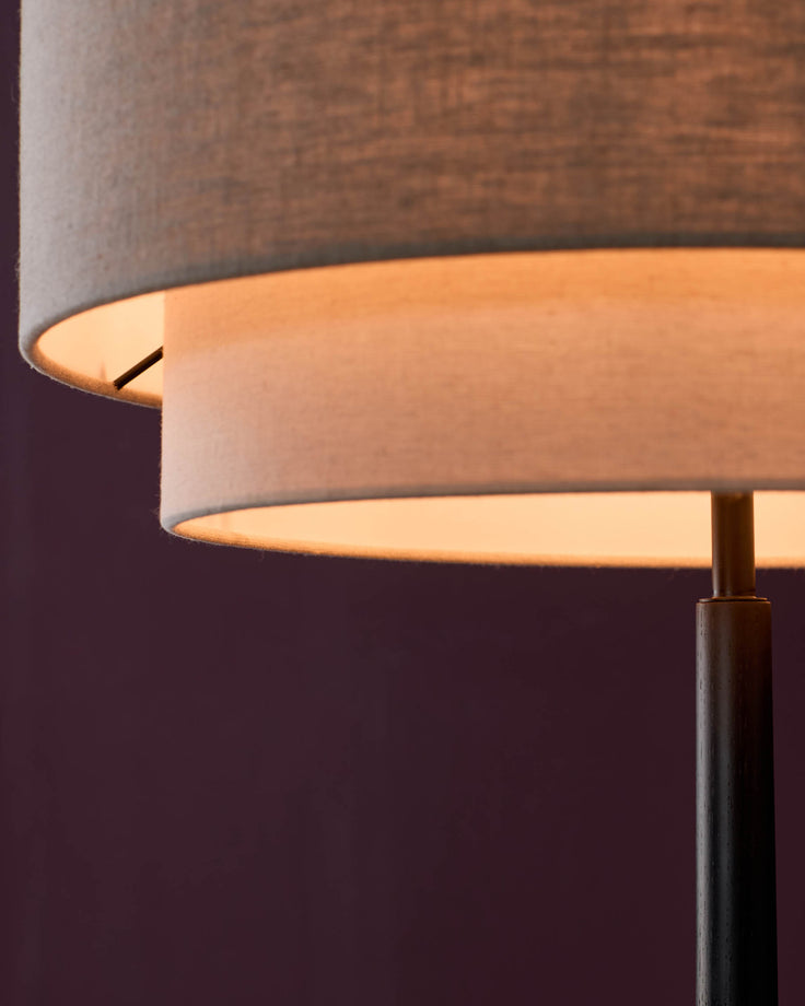 Leonie floor light with natural linen shade and mocha base, shown in soft-lit close-up detail.