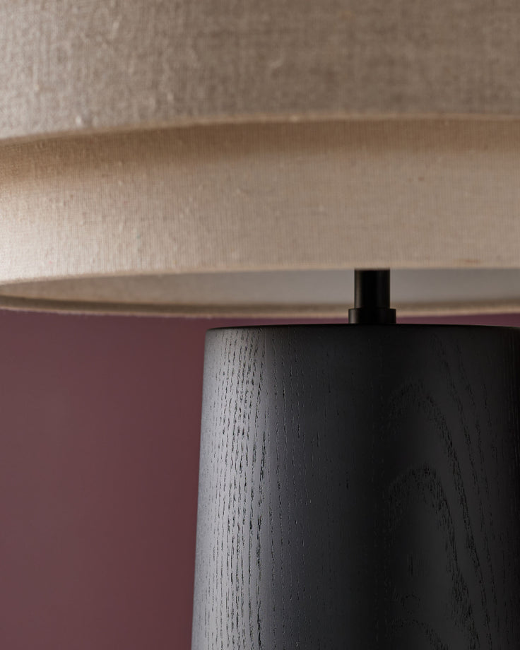 Leonie table lamp with natural linen shade and mocha wood base, side angle view showing cylindrical base and fabric shade.