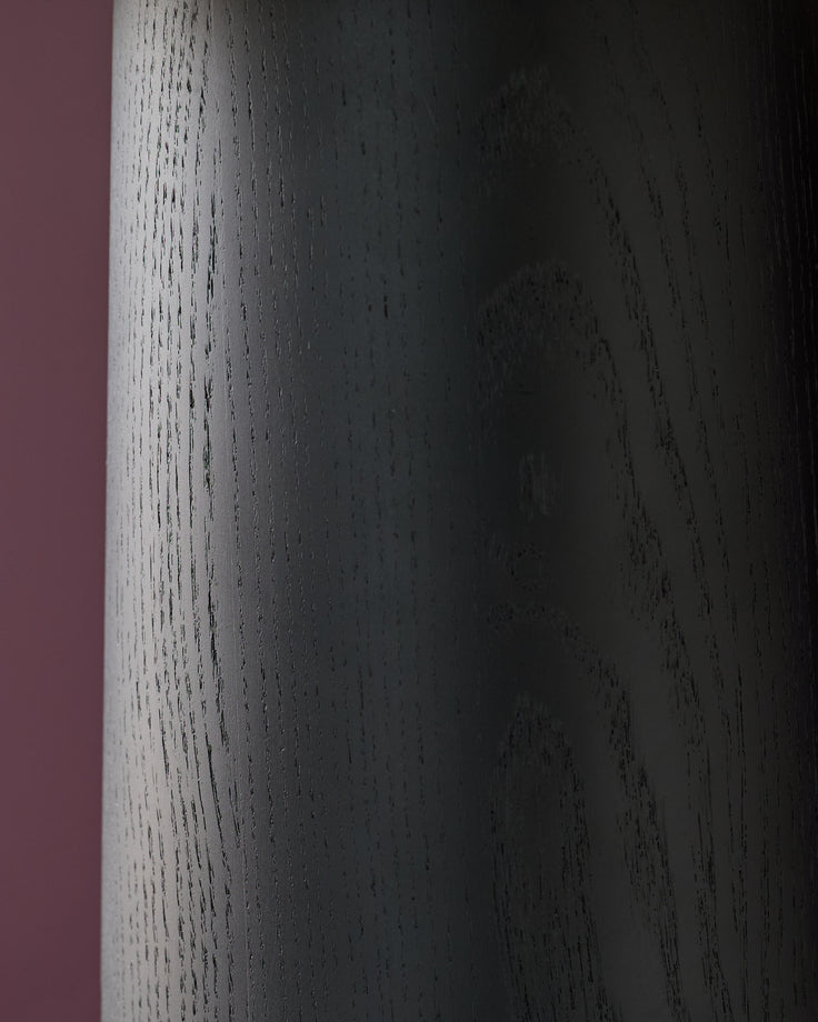 Leonie table light with natural linen shade and mocha base, close-up of textured wood grain detail.