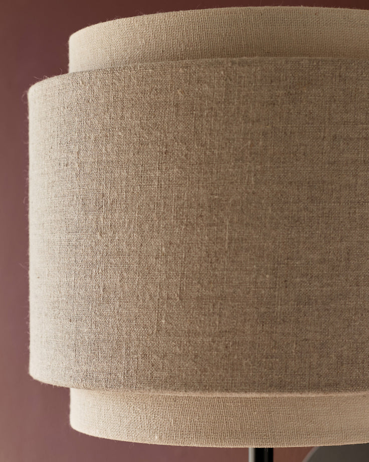 Leonie wall light with natural linen shade and mocha trim, cylindrical design, close-up detail view.