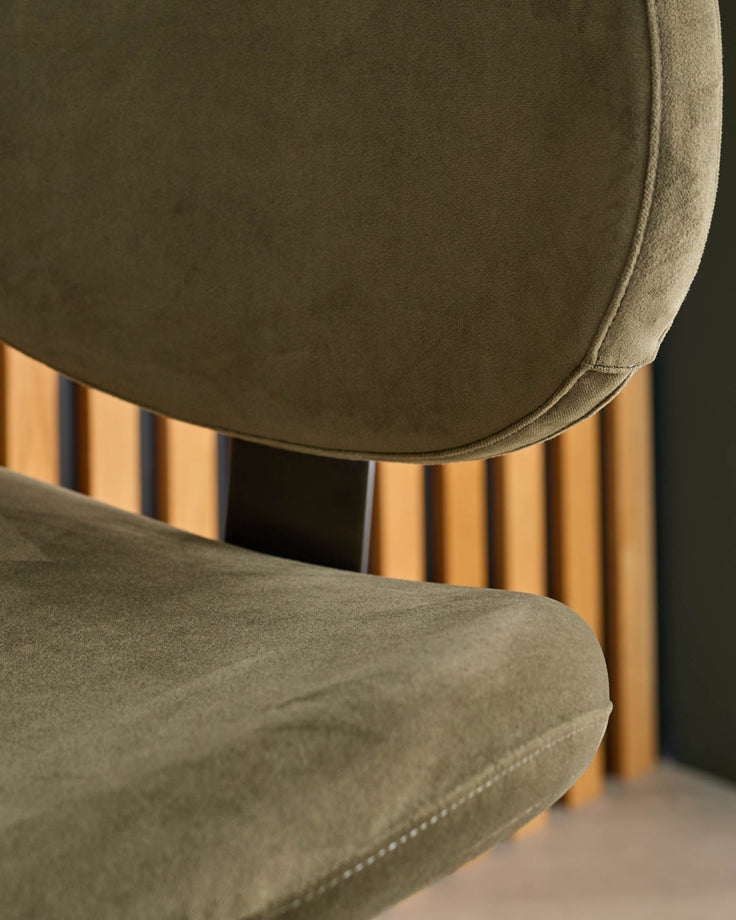 Lilah gas lift bar stool in olive green velvet with natural wood fluted base, side angle view.
