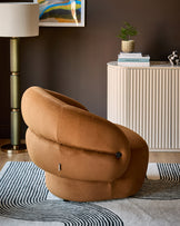 Lillian accent chair in caramel fabric, showcasing its distinctive rounded, cocoon-like silhouette in a styled living room setting.