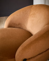 Lillian accent chair in caramel fabric, showing curved rounded silhouette and upholstered design from side angle.
