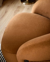 Lillian accent chair in caramel fabric, close-up detail of curved rounded backrest and armrest.