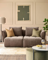 Stylish living room featuring a comfy sofa, patterned rug and round coffee table with a marble top and fruit bowl.