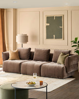 A stylish living room featuring a brown sofa, coffee table, and olive-green accents. Modern elegance at its finest.