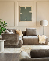 Stylish living room featuring a modular sofa, modern floor lamp, abstract art, and a round side table.