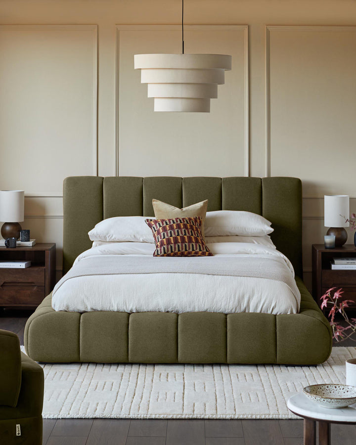 Lillian super king ottoman bed in olive green fabric with quilted headboard and footboard in a styled bedroom setting.