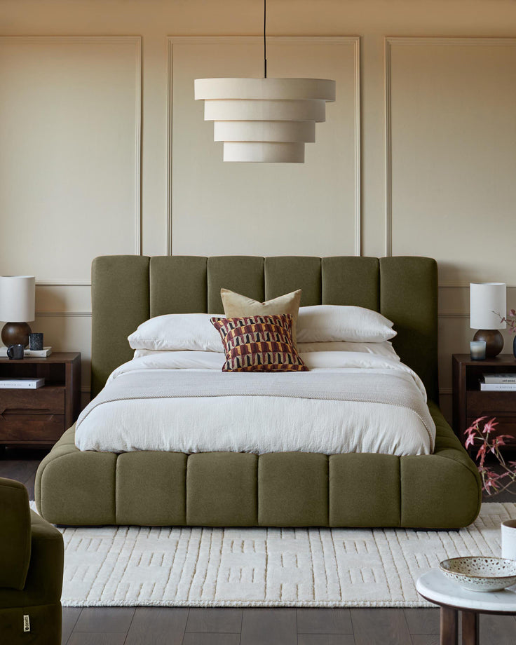 Lillian super king ottoman bed in olive green fabric with quilted headboard and footboard in a styled bedroom setting.