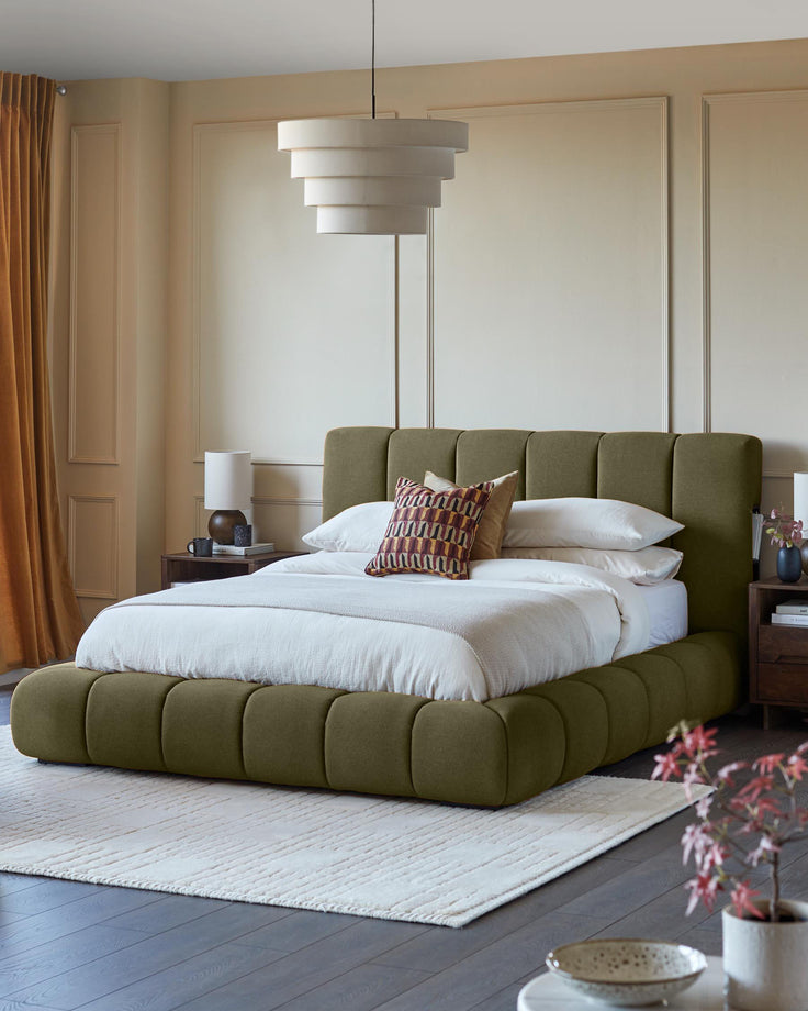 Lillian super king ottoman bed in olive green fabric, shown in a styled bedroom with white bedding and patterned cushion.