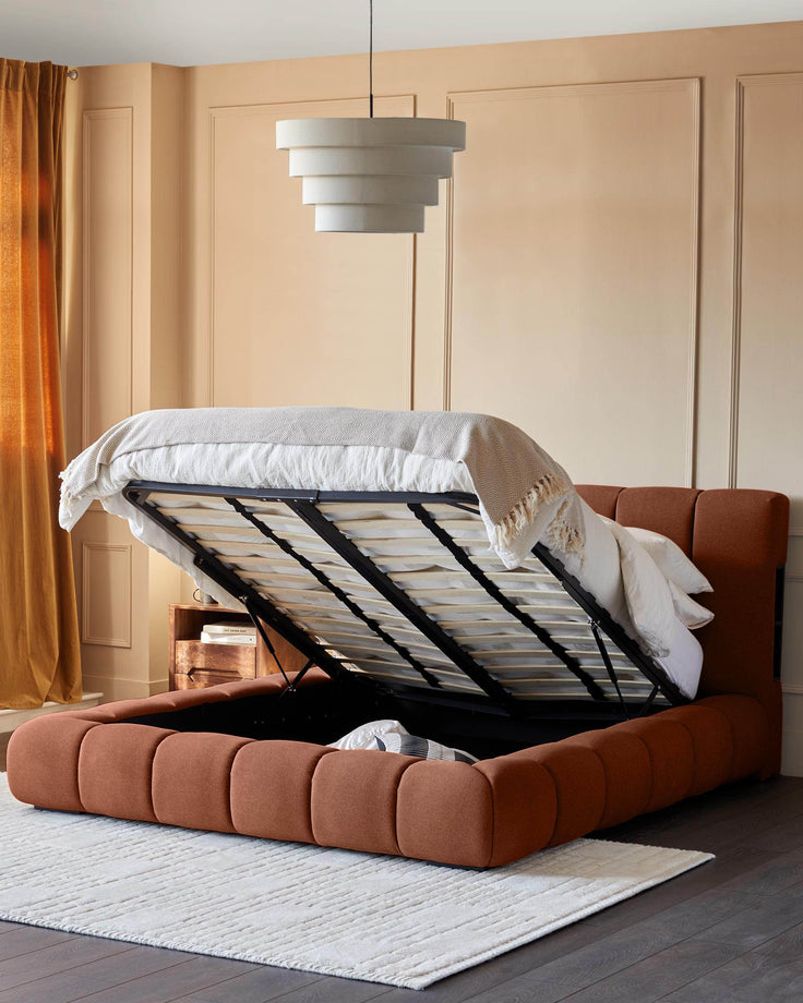 Lillian super king ottoman bed in toffee fabric with storage base open, showing interior storage space and beige bedding.