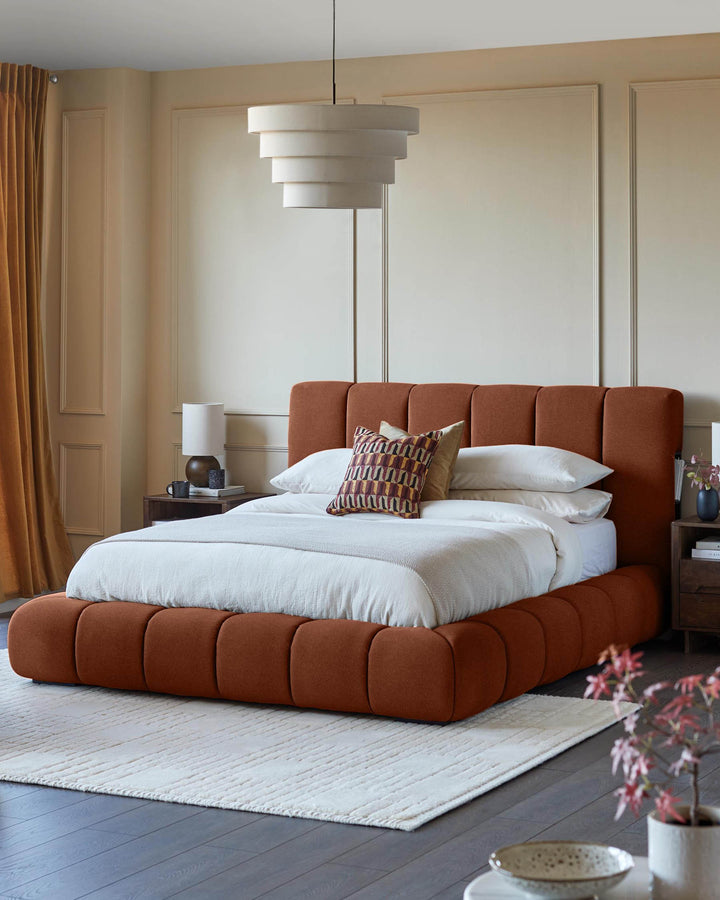 Lillian super king ottoman bed in toffee fabric, shown in a styled bedroom with white bedding and patterned cushions.