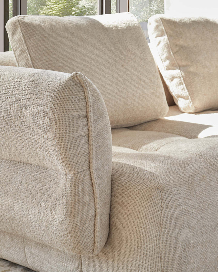 Contemporary beige sofa with thick cushions, showcasing a cozy and inviting texture, ideal for modern living spaces.