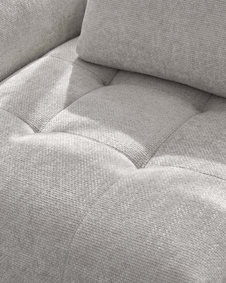 Lillian right corner chaise sofa in light grey weave fabric, close-up detail of cushioned seating and armrest.