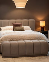Lillian Bench in mocha fabric with quilted channel design, positioned at foot of bed in modern bedroom setting.