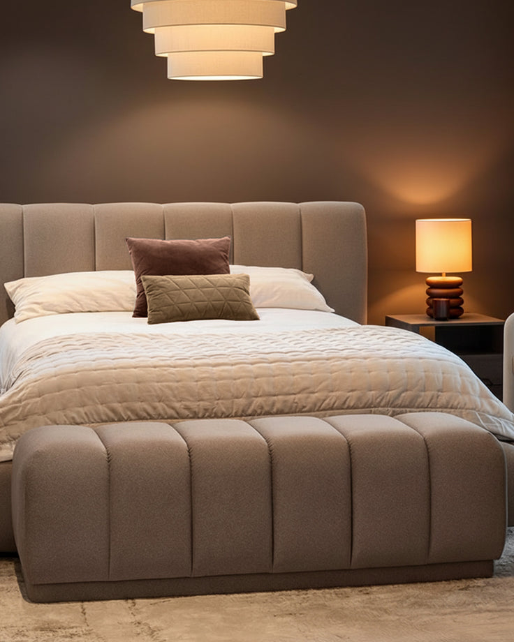 Lillian Bench in mocha fabric with quilted channel design, positioned at foot of bed in modern bedroom setting.