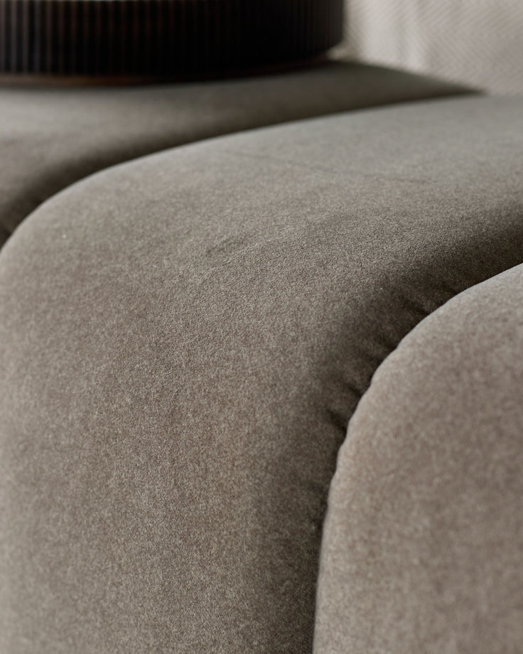 Lillian Bench in mocha fabric, close-up detail showing soft upholstered surface and curved seating form.