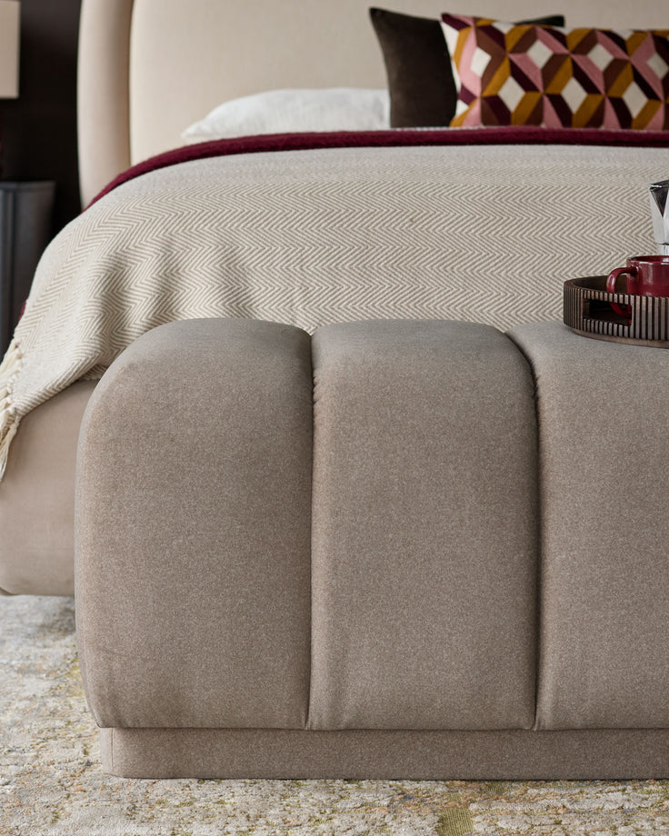 Lillian fabric bench in mocha, featuring a rounded, cushioned design with vertical channel tufting and a neutral color palette.