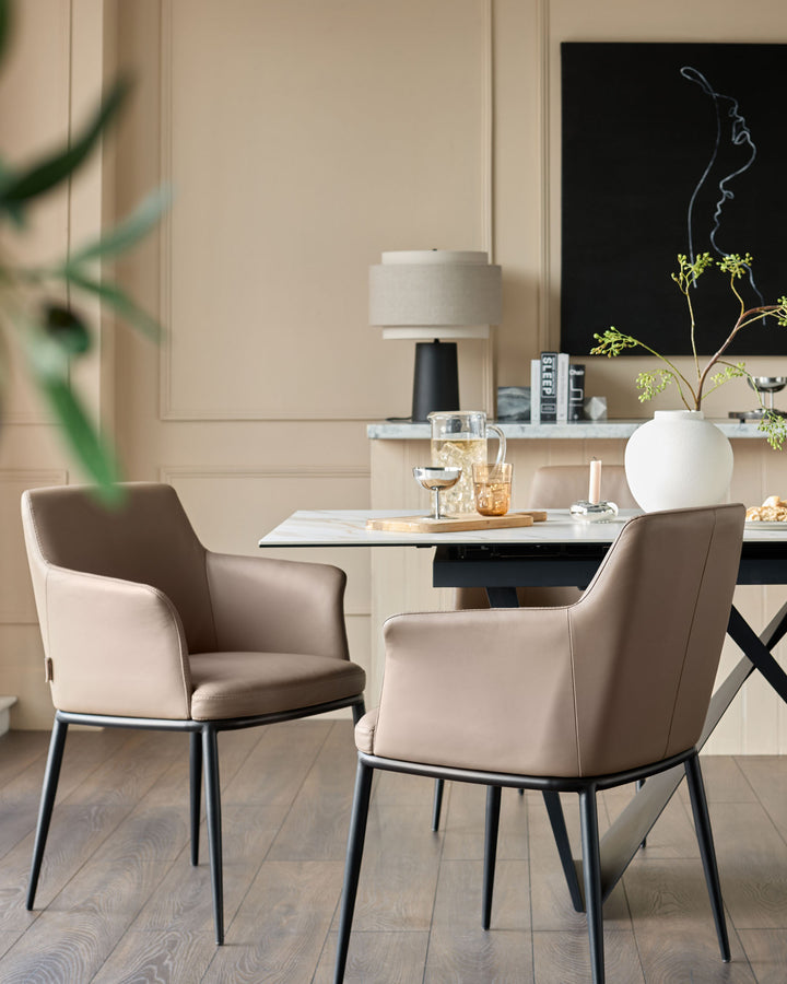 Logan dining chair in mocha leather with black metal legs, shown in a modern dining setting.