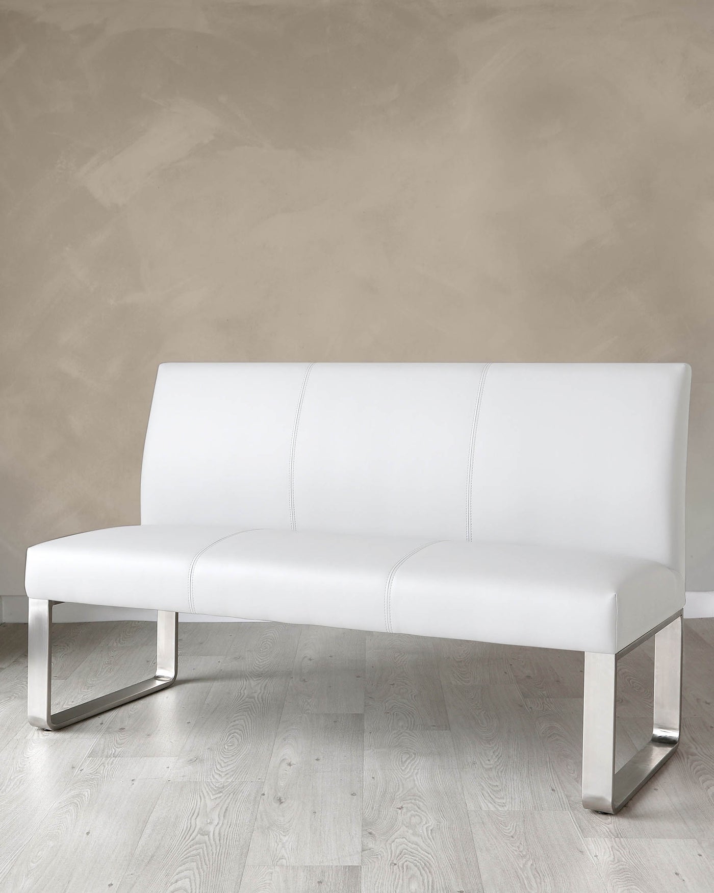 Modern white faux leather bench with a sleek, minimalist design featuring a straight backrest, cushioned seat with subtle stitching details, and shiny metallic U-shaped legs.