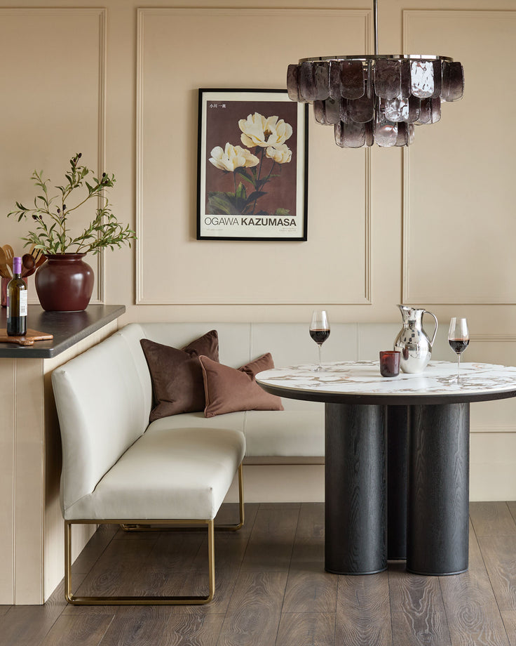 Light grey faux leather corner dining bench with brushed brass legs, shown in modern dining room setting.